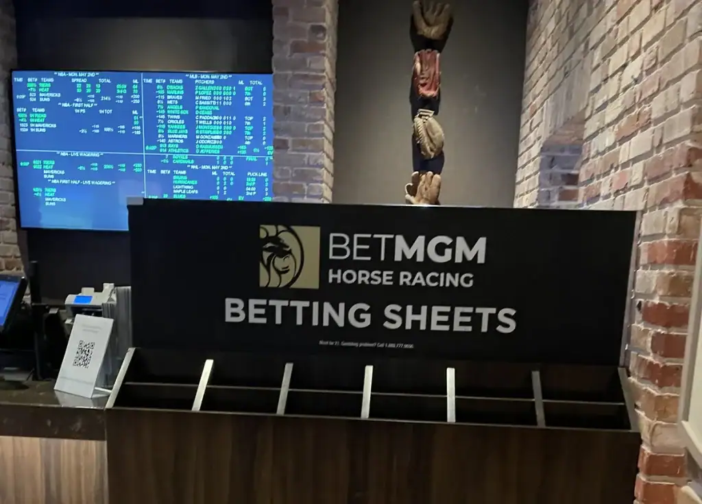 BetMGM sportsbook counter at Beau Rivage, Biloxi, with odds boards and betting sheets